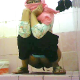 An Asian Muslim girl wearing glasses takes a lengthy shit while squatting over a public floor toilet. She does not appear to be aware of the hidden camera in the bathroom. She rinses her ass with a bowl of water when done. Over 4.5 minutes.